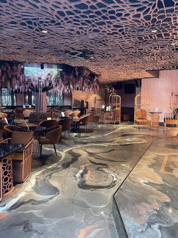 Bespoke lounge fit-out with sculpted copper ceiling and wisteria feature, London